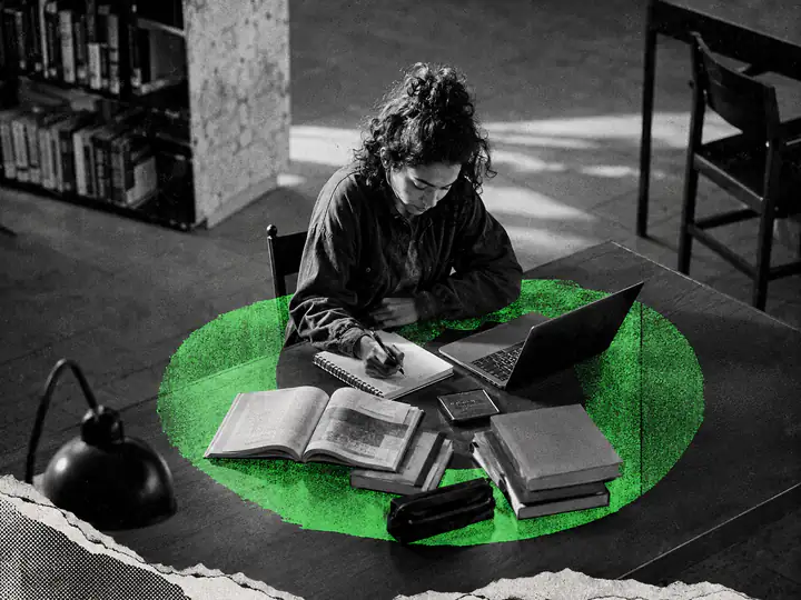 An adult writes in a notebook in a library, with books and a laptop inside a green circle.